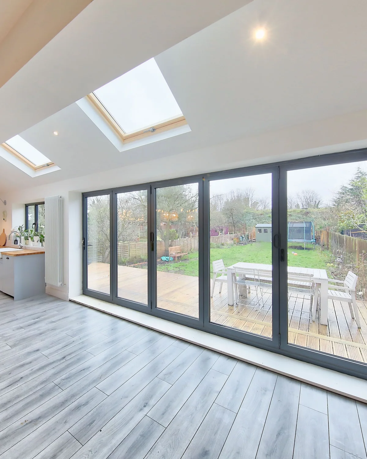 Rear extension interior with rooflights, glazed doors and a clear connection to the garden.